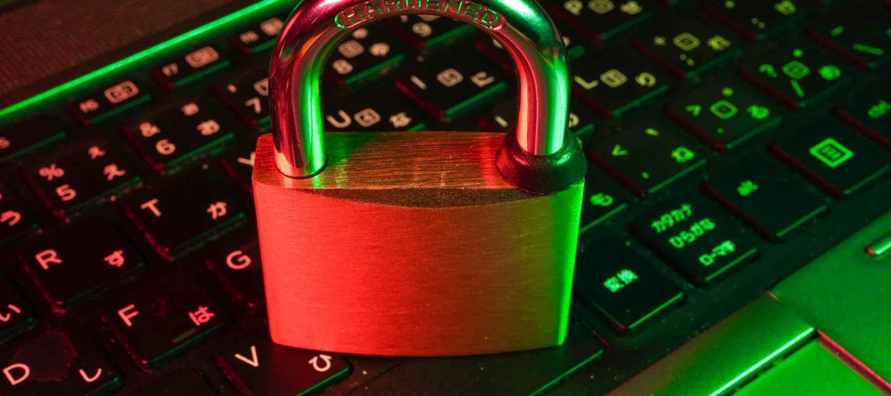 Red padlock on keyboard — digital data vulnerability